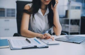 woman-talk-mobile-phones-and-working-on-laptop-computers