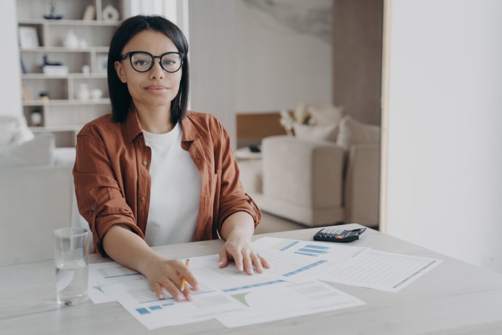 female-bookkeeper-freelancer-in-glasses-sitting-at-desk