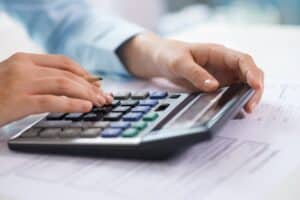 closeup-economist-working-counting-data-calculator