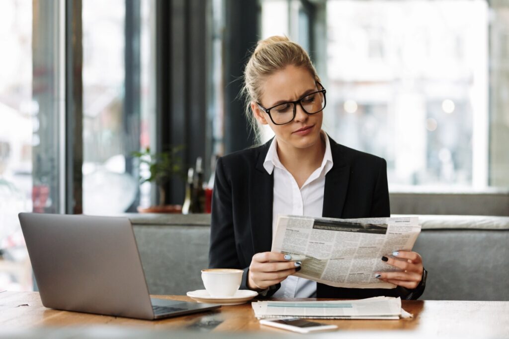 concentrated-business-woman-reading-newspaper