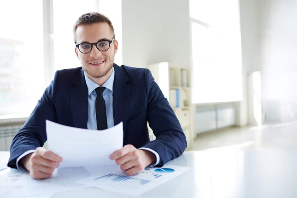 employee-with-glasses-holding-report