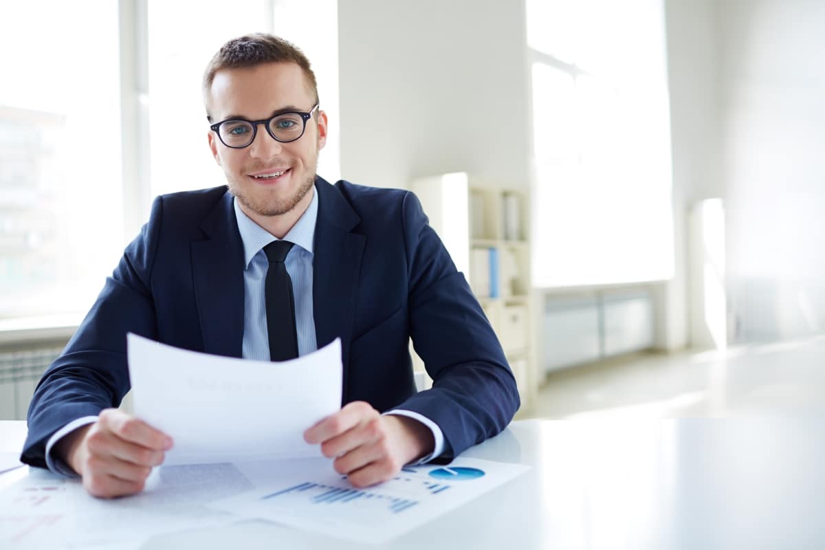 employee-with-glasses-holding-report