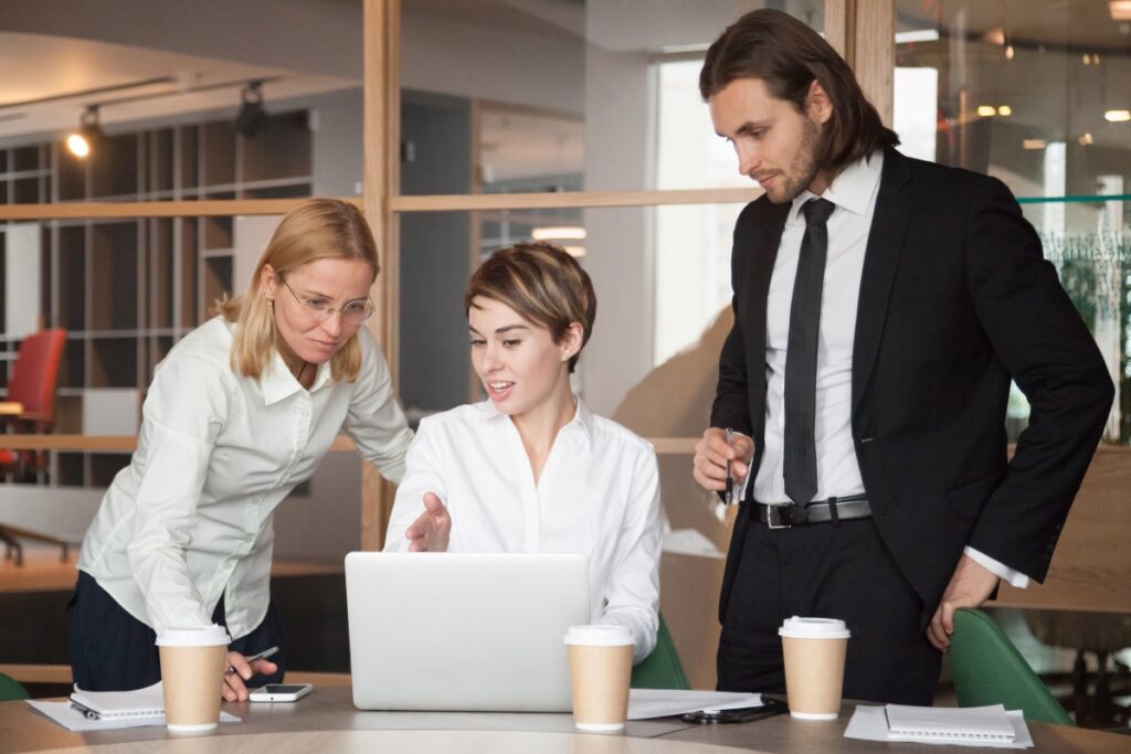 business-partners-negotiating-about-strategies-using-laptop