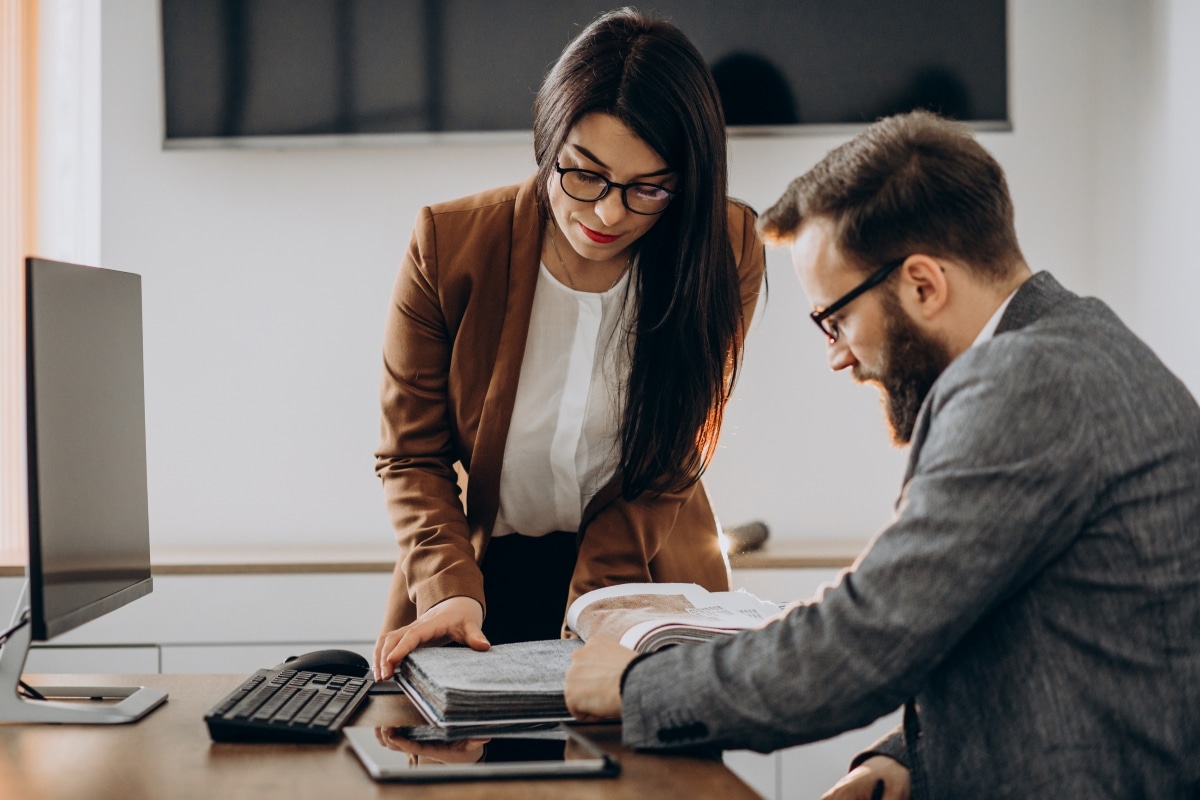 two-business-partners-working-together-office-computer